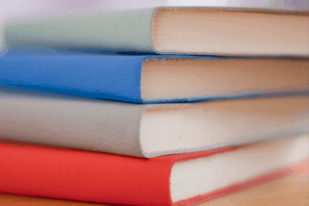 Stack of multi-colored books for a blog post about building trust through storytelling